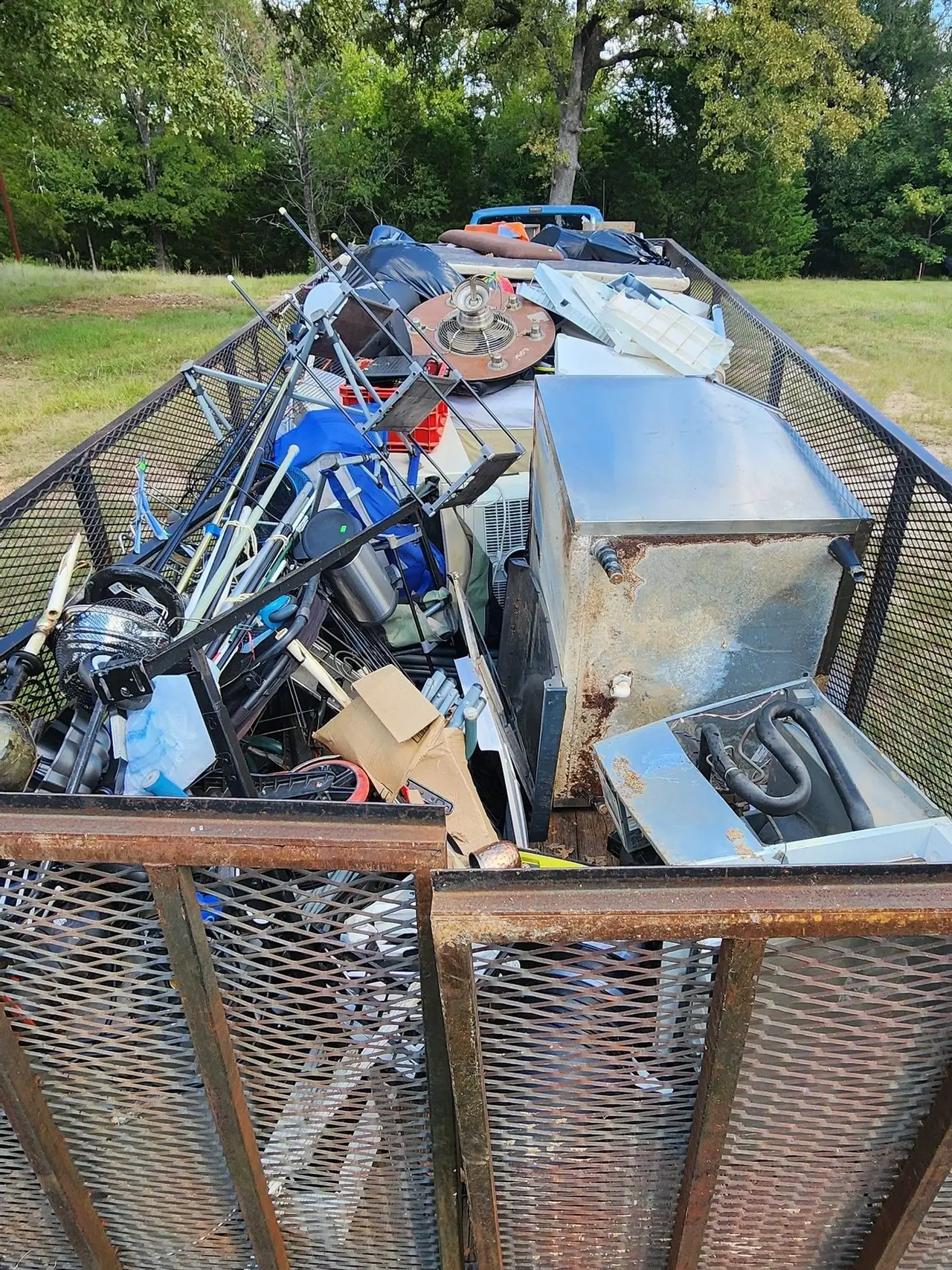 A loaded trailer of appliances and household goods.